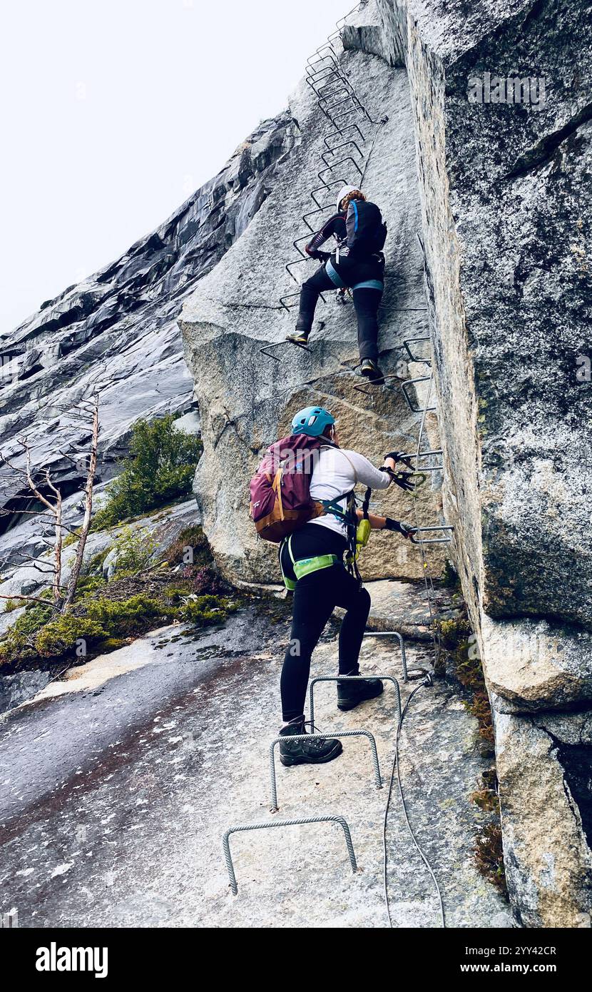 Climbers climbing Trolltunga via-Ferrata in Norway - Smartphone Captured Stock Image