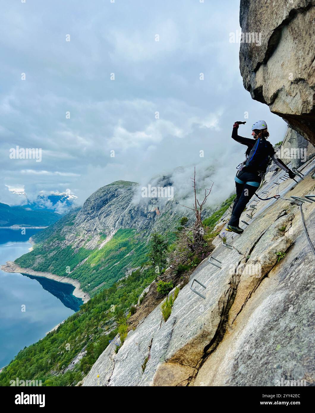 Climbers climbing Trolltunga via-Ferrata in Norway - Smartphone Captured Stock Image