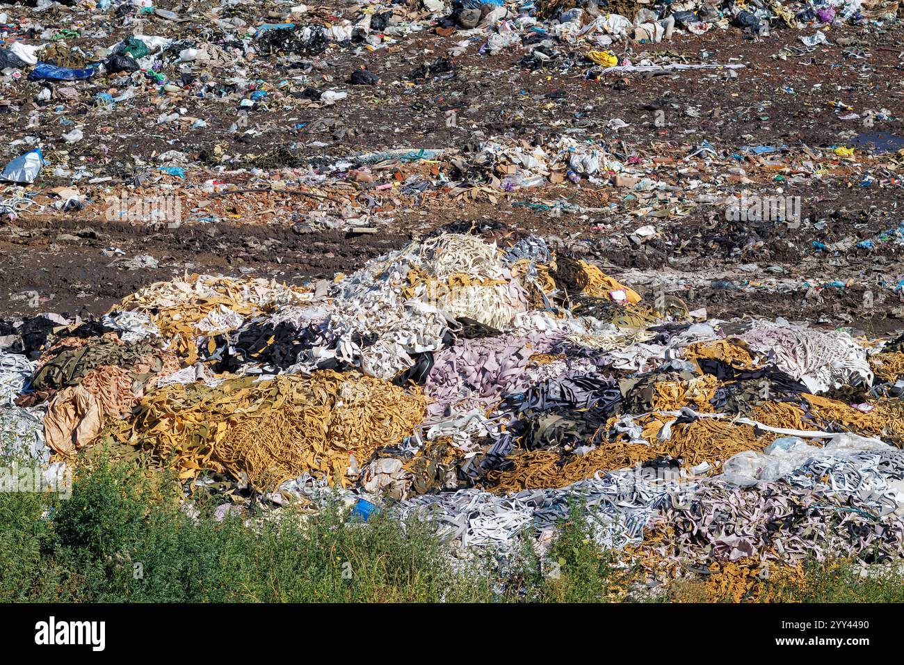 A view of a city dump or landfill. A pile of plastic garbage, food waste and other garbage. Pollution of nature. The concept of ecology Stock Photo