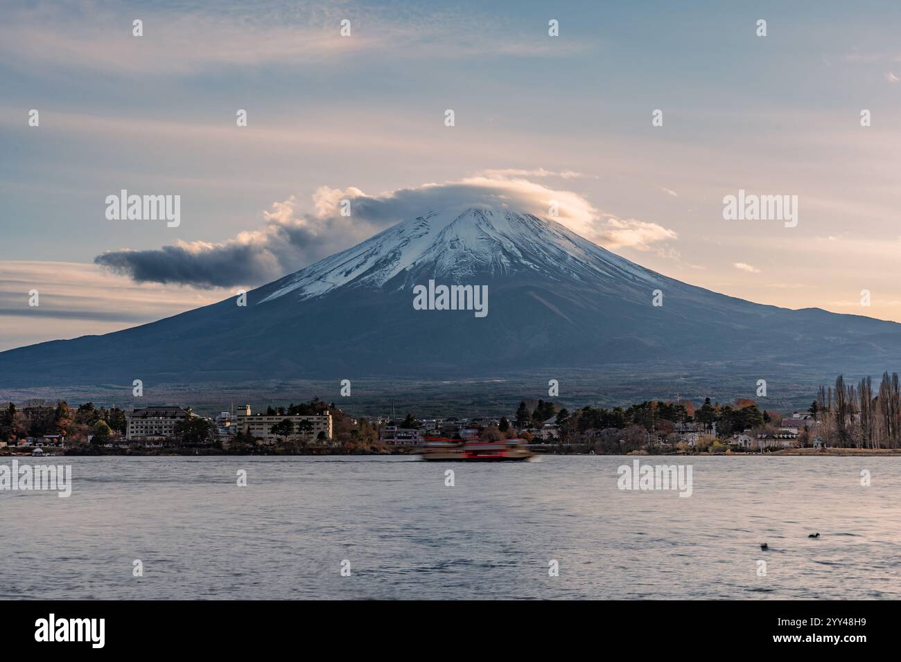 View of Mount Fuji during sunset with moving cloud on top of the mountain Stock Photo