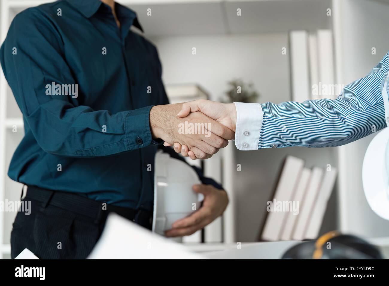 Professional Engineers and Architects Collaborating on Modern Building Design Project Stock Photo