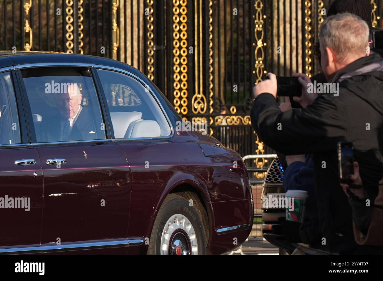 A members of the public takes a photo of King Charles III arriving for(02)