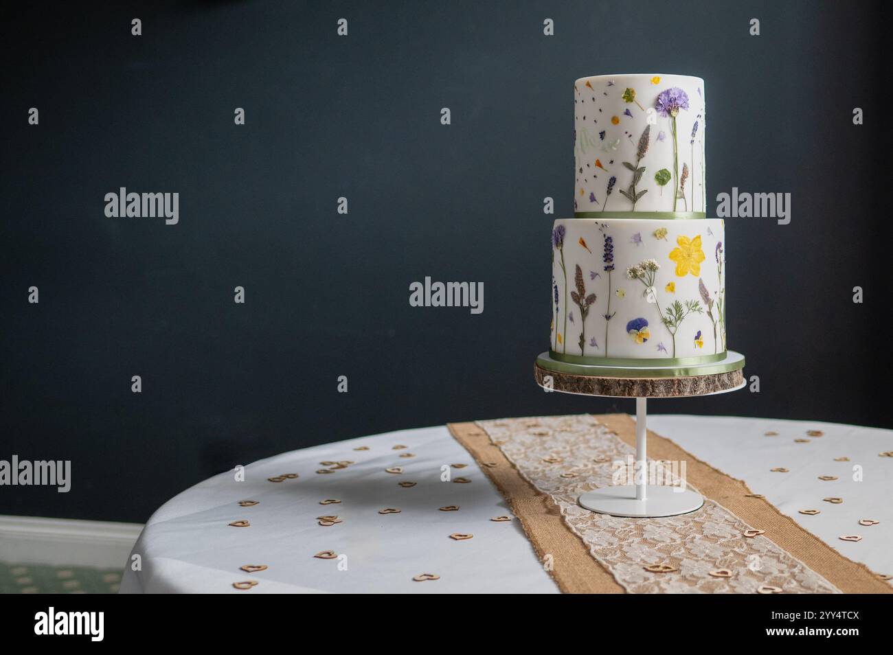 wedding cake on table with room blurred in background Stock Photo