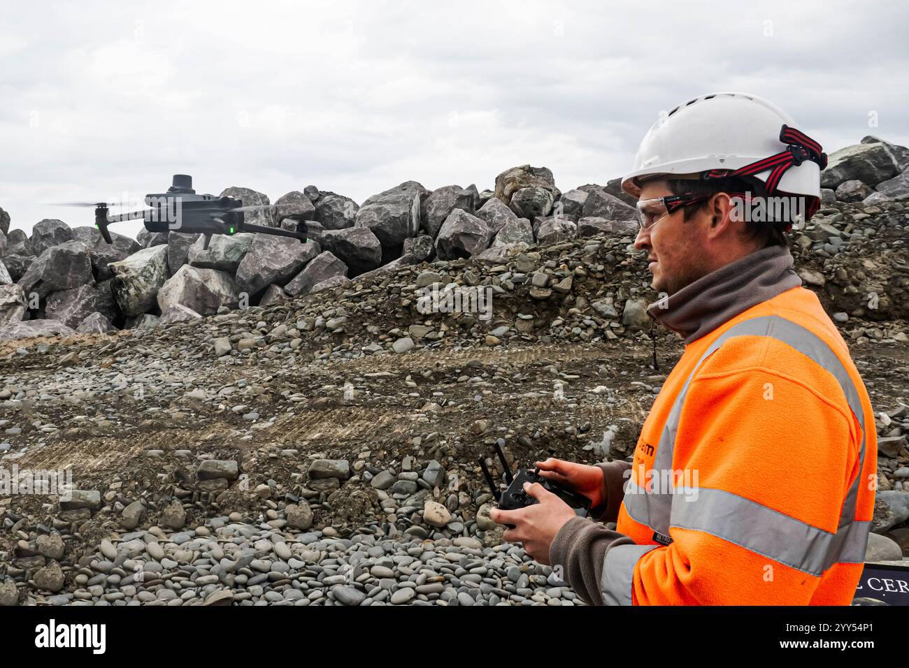 dump trucks transporting rocks for a water brake Stock Photo - Alamy