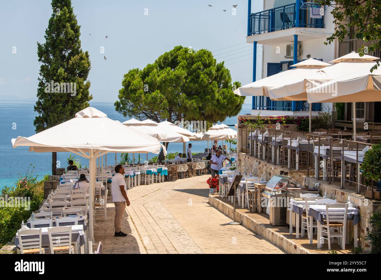 Restaurants and taverns next to sea in historical town. Situated on top of a hill the village of Afitos or Athitos, features stone houses Stock Photo