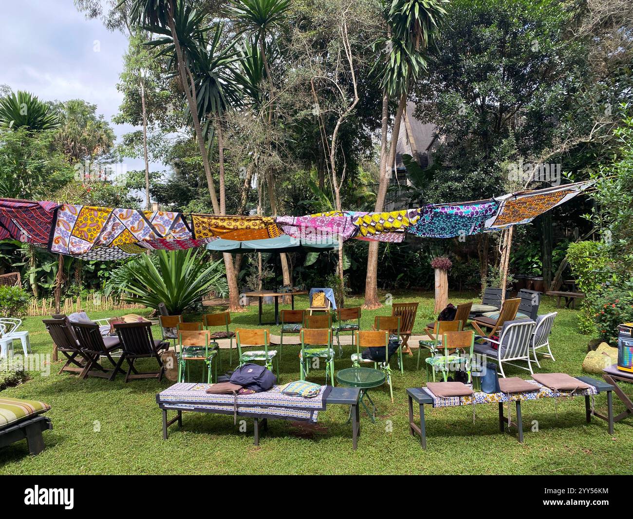 Random and Colorful setup of chairs and seating in a green nature background - Smartphone Captured Stock Image