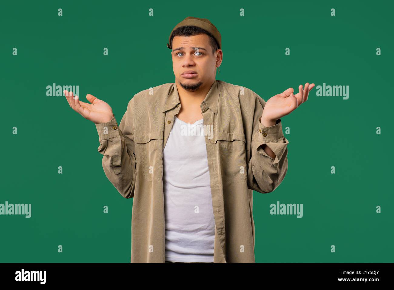 Confused mixed race man, shoulders up - can't help, makes gesture I ...