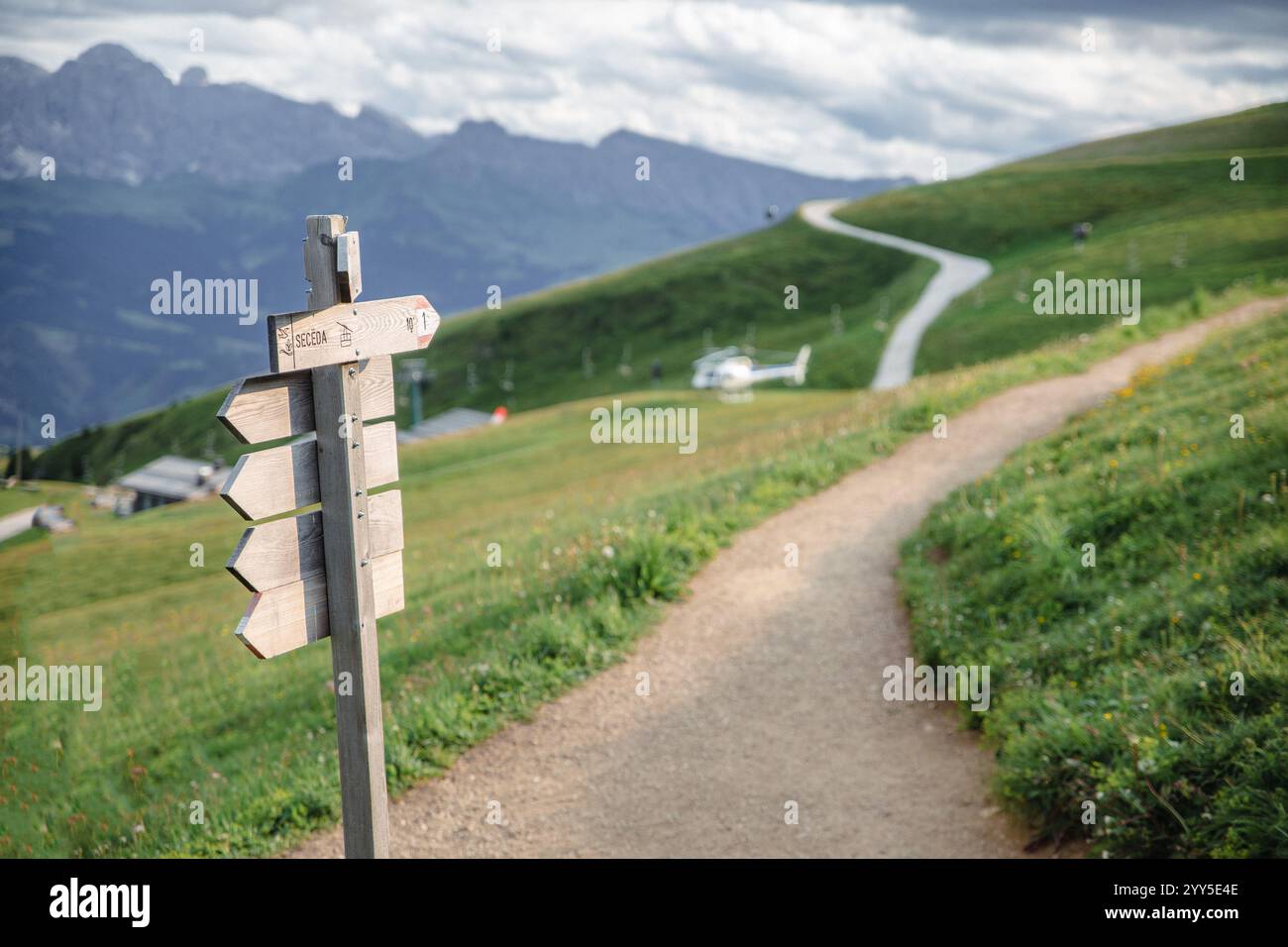 Signposts In Seceda the road sign of Seceda pointing to a hiking trail along a green hill ...