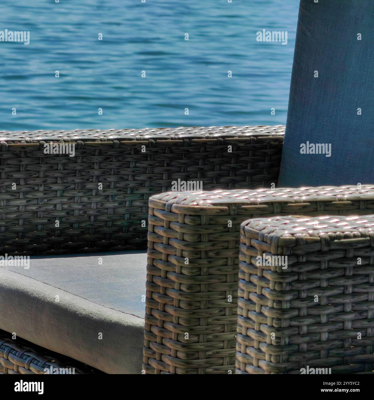 Shoreline Solitude. A Chair by the Lake. Summer time vibes. Cool Breeze. Stock Photo
