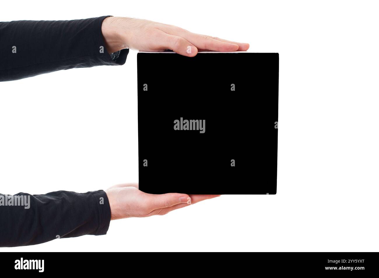 Pair of hands presenting a blank square box on a white background. Marketing, packaging, or design related concept. Stock Photo
