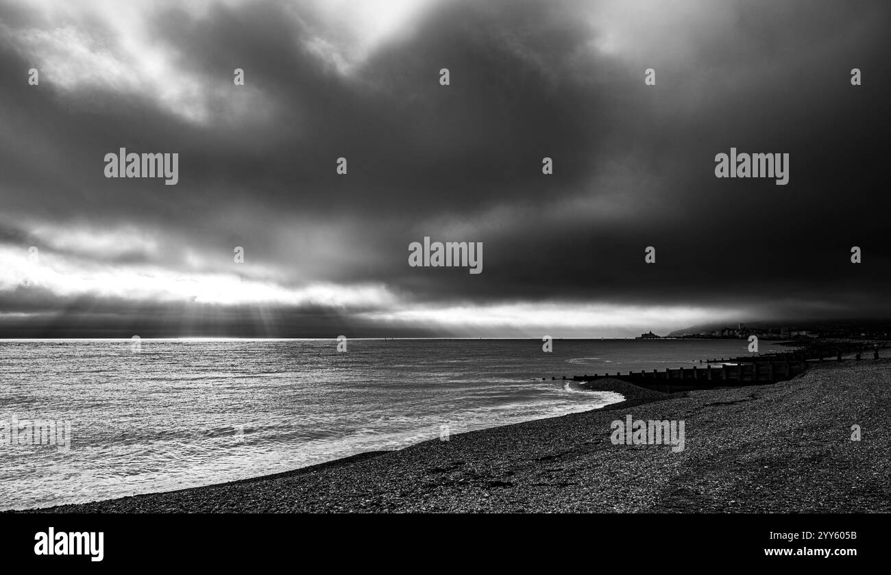 View of the Eastbourne seafront from the east side of the Town, under a dramatic December cloudy sky Stock Photo