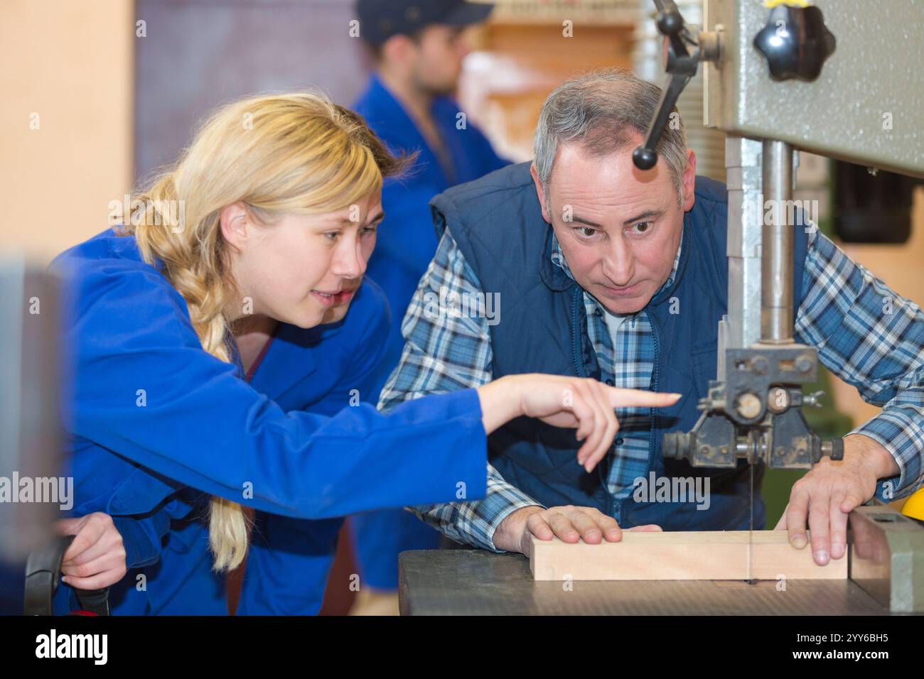 operating drilling machine making furniture in woodworking shop Stock Photo