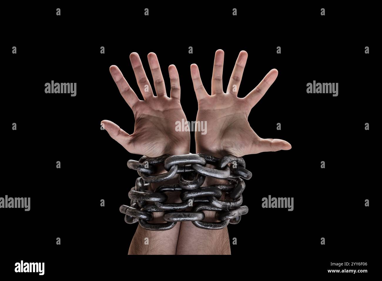 Two hands in chains isolated on black background with clipping path Stock Photo