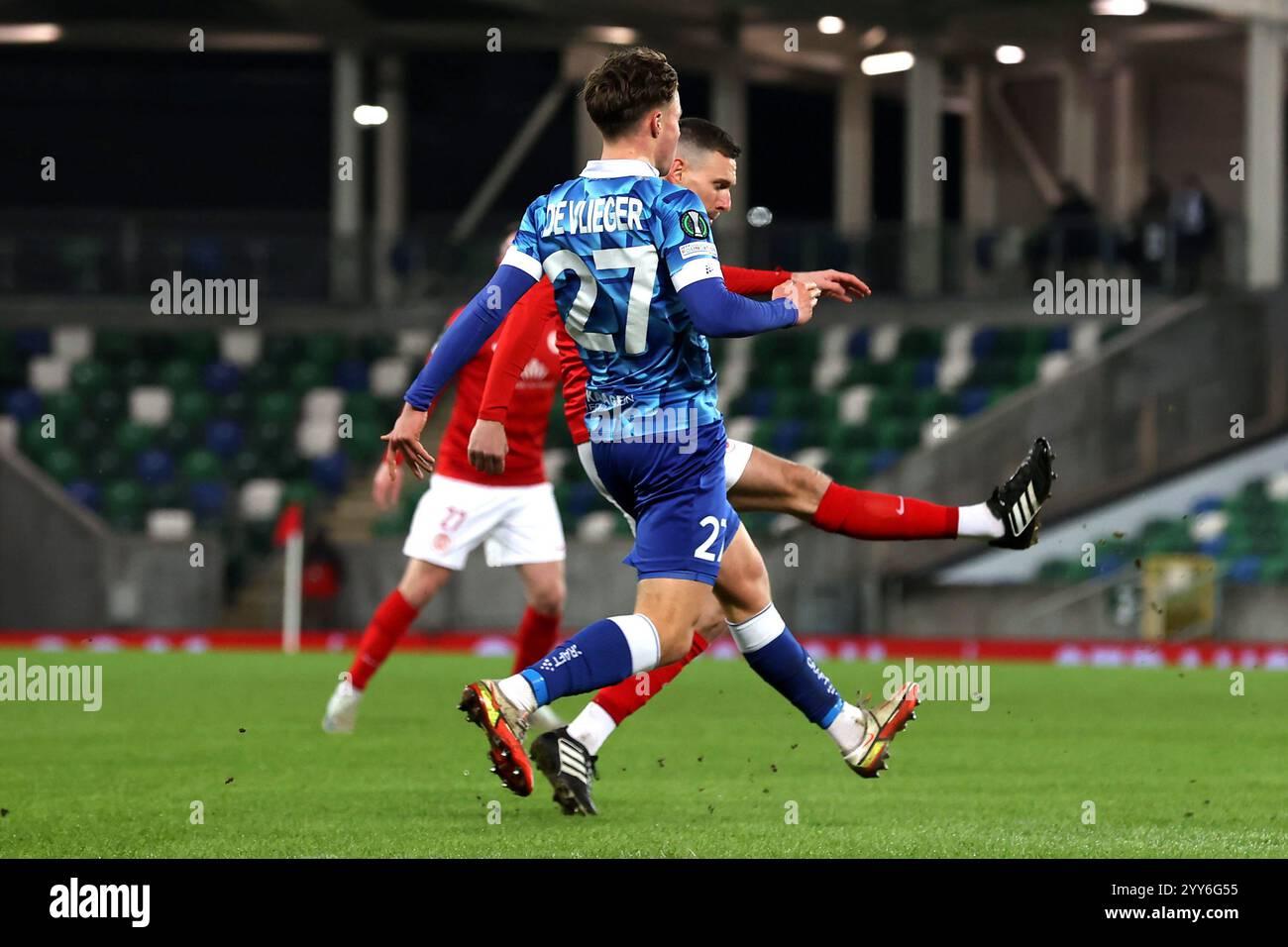 Larne's Mark Randall (right) attempts to hit a half volley towards goal ...