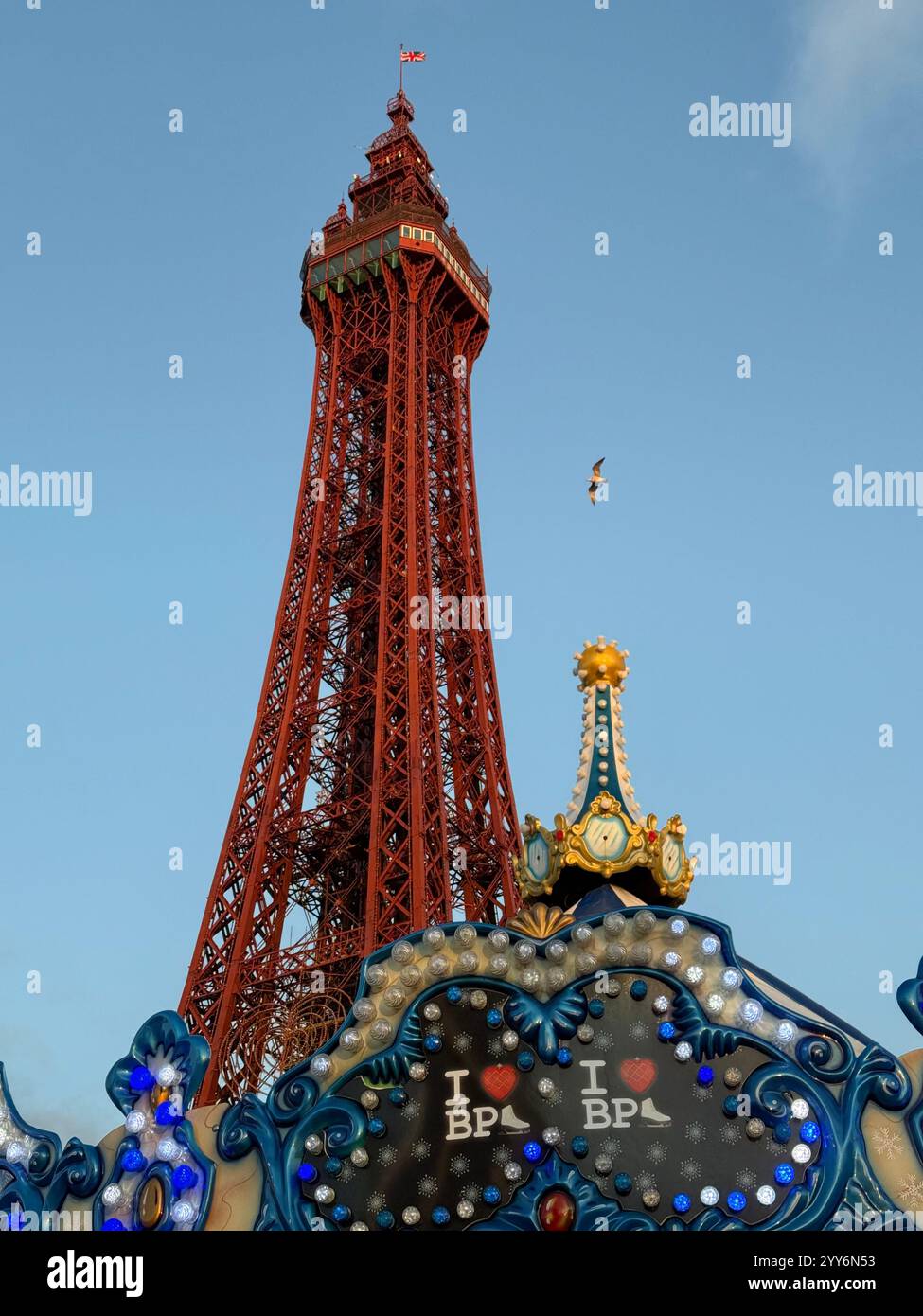 Blackpool Tower and top of merry go round on winter market in front of the Tower against a blue sky. - Smartphone Captured Stock Image