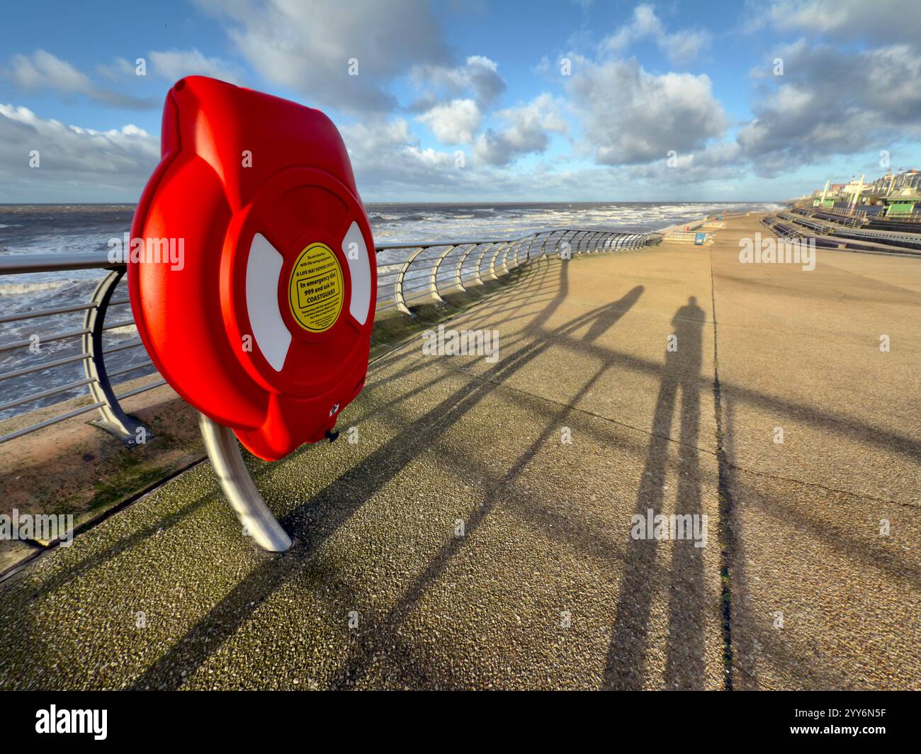 Life belt on North promenade at Blackpool with shadow of photographer. High tide on wide winter day. - Smartphone Captured Stock Image
