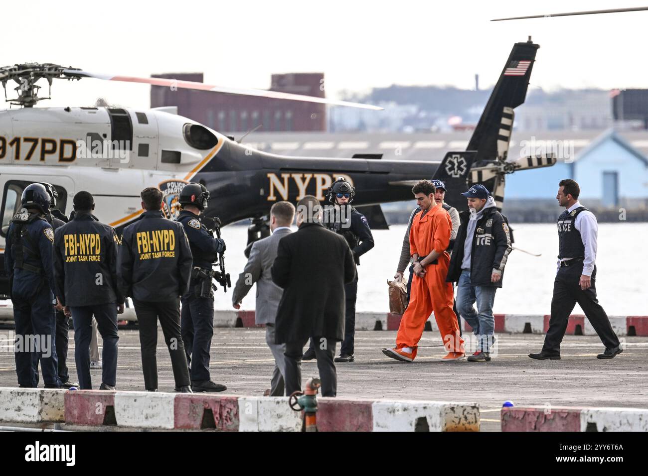 New York, USA. 19th Dec, 2024. Members of the NYPD escort Luigi ...