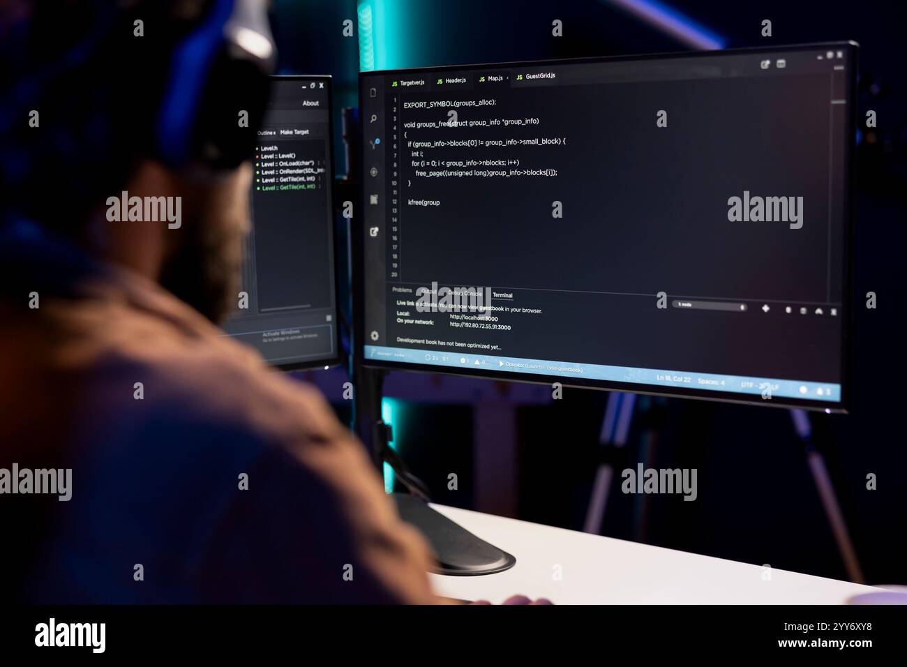 Programmer writing code on computer to futureproof company network from downtimes and unexpected system failures. Man deploying programming script increasing data security Stock Photo