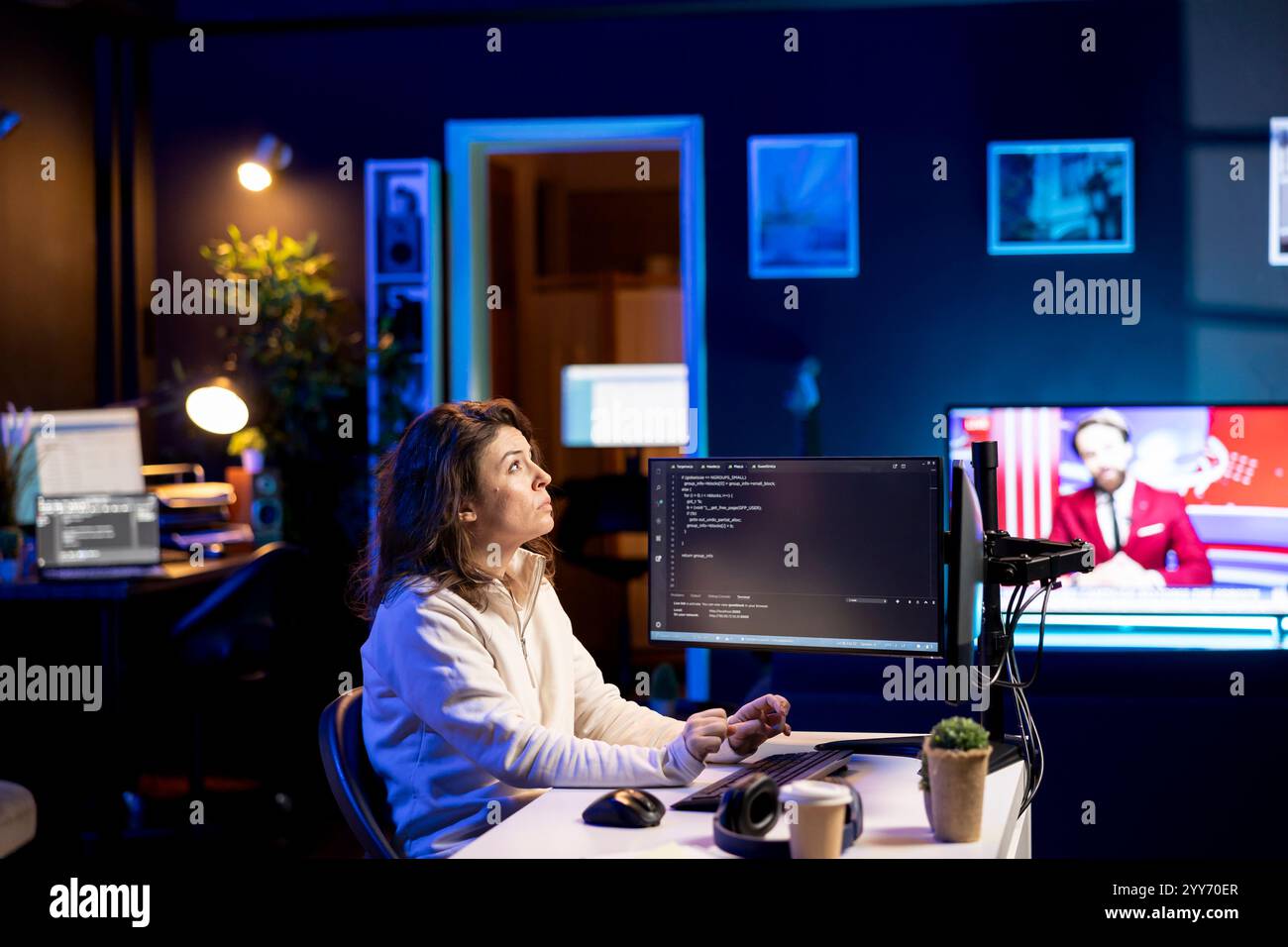 Developer in neon lit apartment implement security measures using augmented reality tech, protecting data. System administrator working from home, debugging code, looking at AR visualization Stock Photo