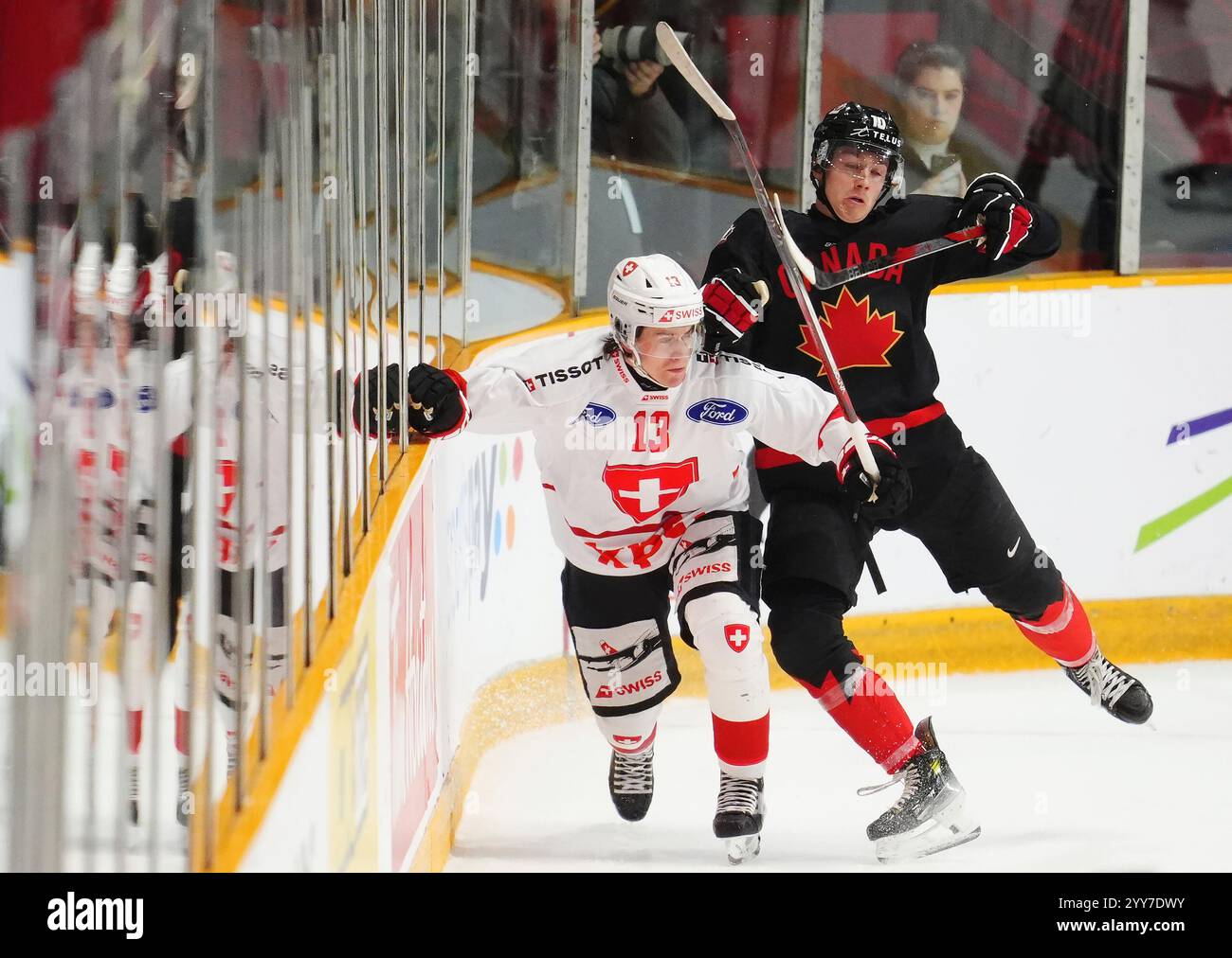 Switzerland's Janis Embacher (13) and Canada's Bradly Nadeau (10