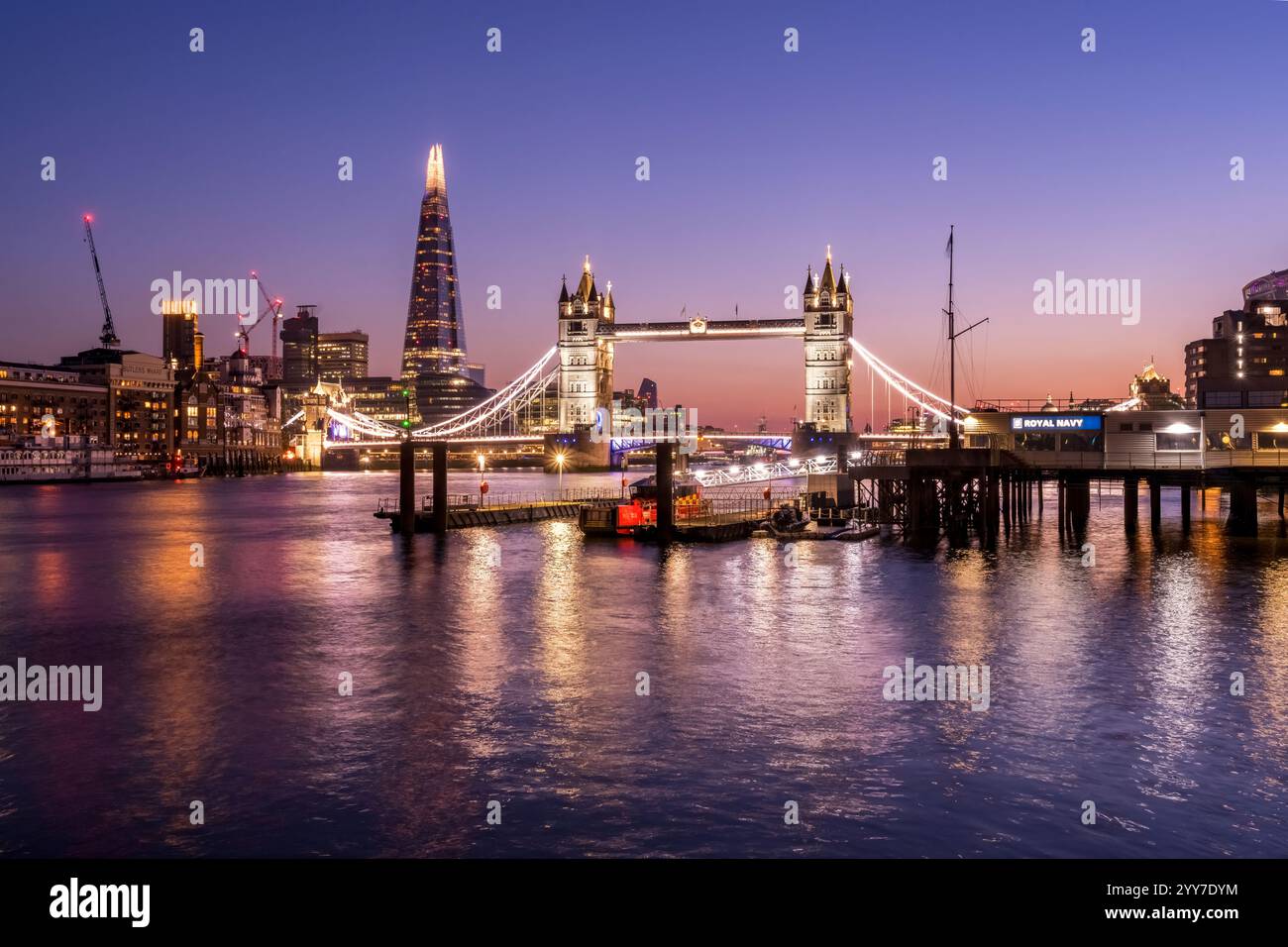 Tower Bridge glowing in the London twilight—an iconic view that never fails to inspire. Stock Photo