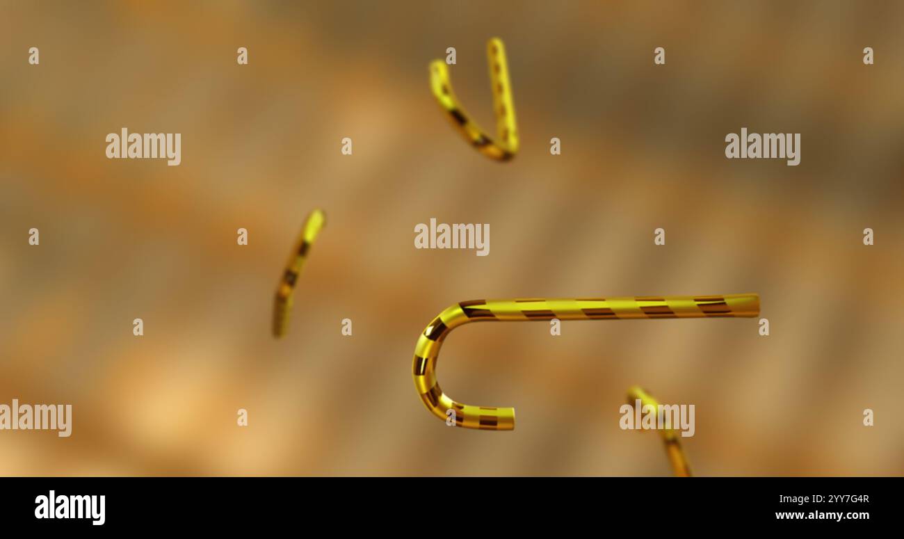 Image of christmas gold candy canes falling over gold background