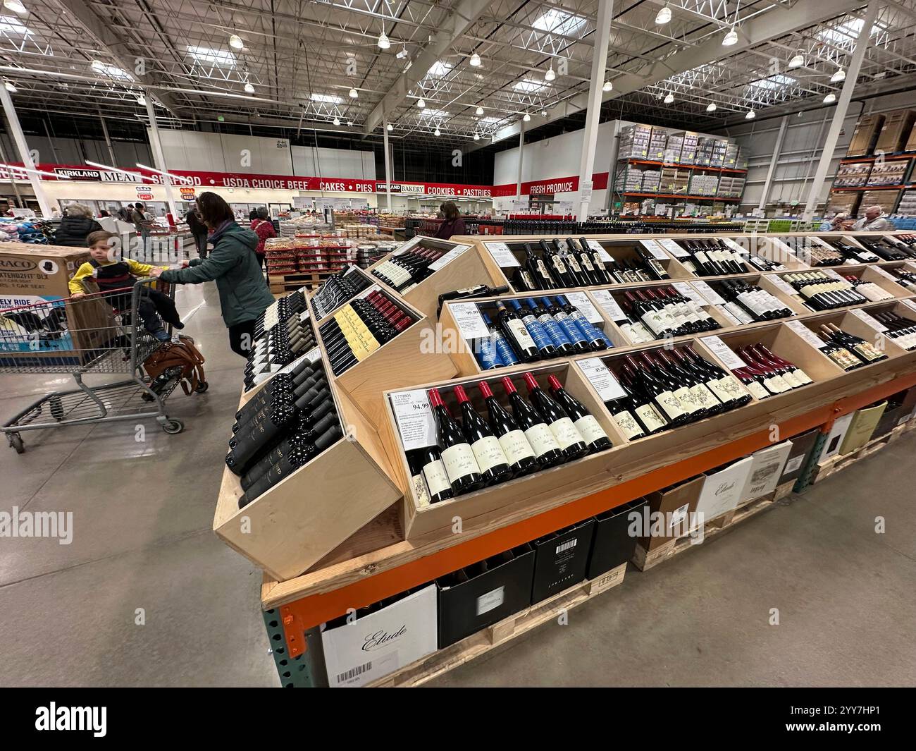 A shopper passes by a display of wine in a Costco warehouse Thursday ...