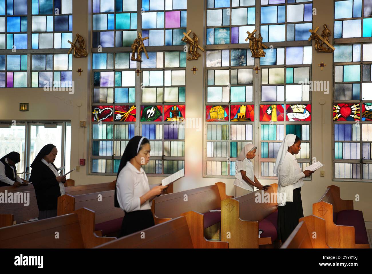 Sisters of the Holy Family sing during Mass in the chapel of the