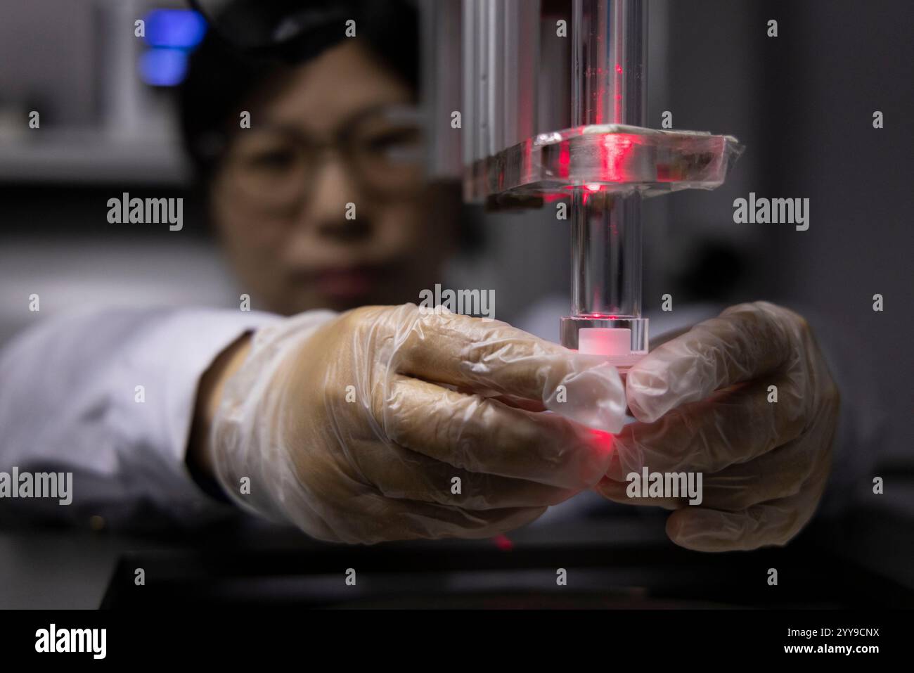 (241220) -- BEIJING, Dec. 20, 2024 (Xinhua) -- Researcher Cai Shuhui places rock sample collected by China's Chang'e-6 lunar probe at a lab of the Institute of Geology and Geophysics under the Chinese Academy of Sciences in Beijing, capital of China, Dec. 20, 2024. Rock samples collected from the moon's far side by China's Chang'e-6 lunar probe have provided groundbreaking insights into the evolution of the lunar body's magnetic field. Analysis of the samples, published on Thursday in the journal Nature, indicates the unexpected resurgence in strength of the moon's magnetic field 2.8 billion Stock Photo