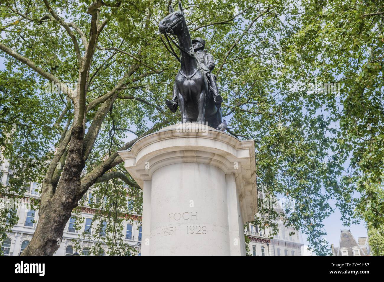 Bronze equestrian statue on a tall pedestal surrounded by green trees in an urban park setting, London, England, July 20, 2023 Stock Photo