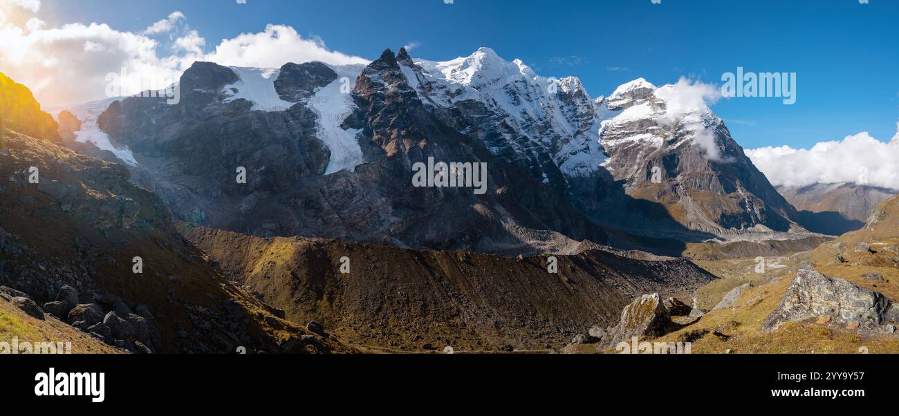 Panoramic photo Mera peak 6476m with glacier lakes and snowy summits covered in white clouds. Himalayas climbing route near the Khare settlement, Maka Stock Photo