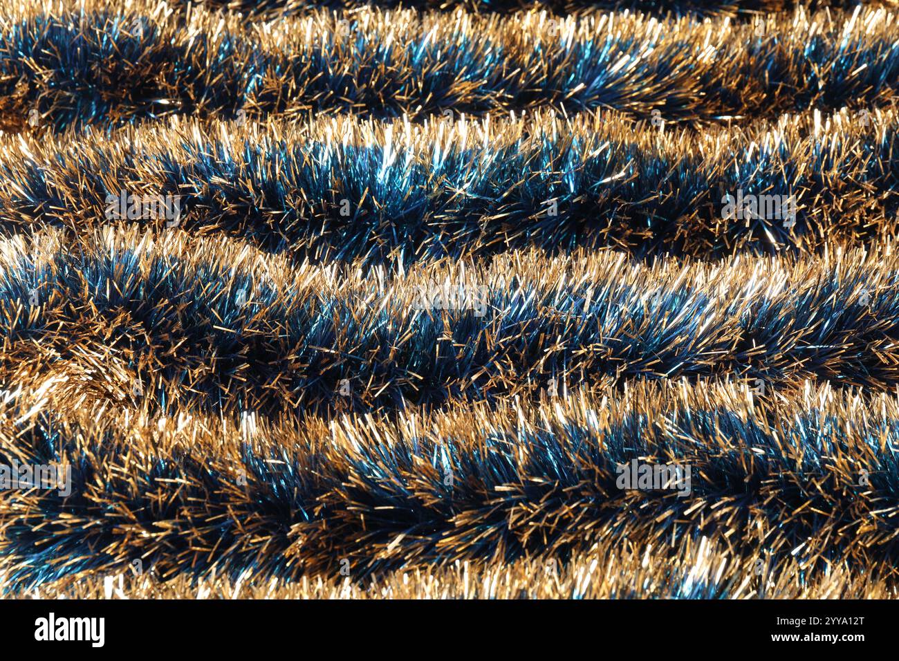 Beautiful shiny tinsel as background, closeup view Stock Photo