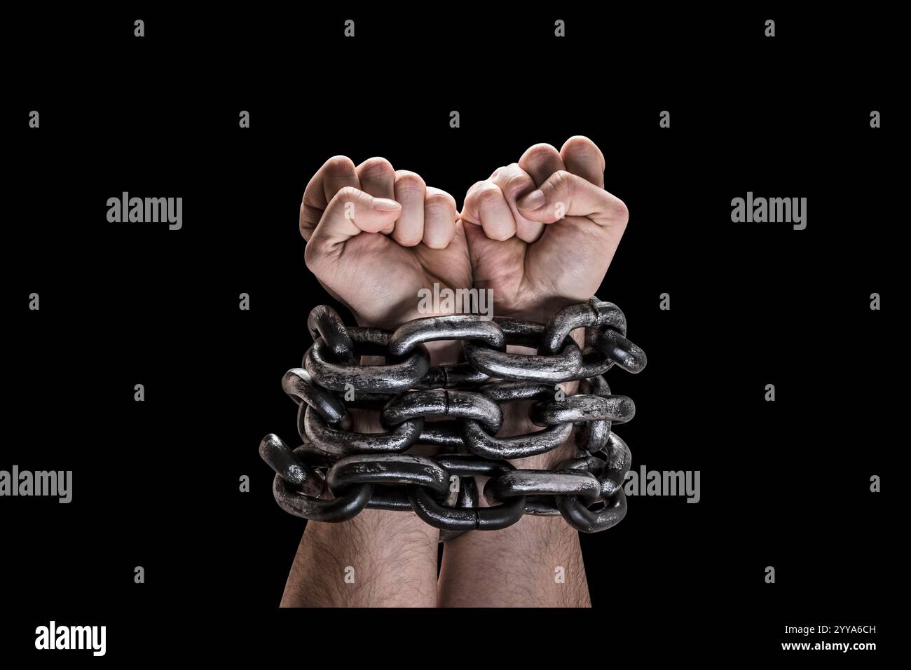 Two hands in chains isolated on black background with clipping path Stock Photo
