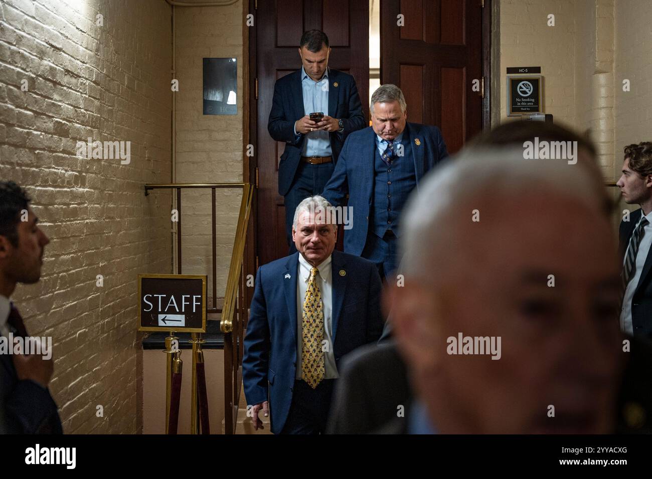 Republican House members exit their conference meeting to discuss next