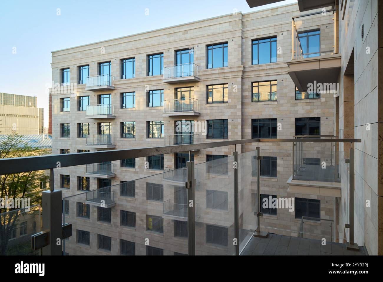 View of A modern apartment building featuring attractive balconies and sleek ...