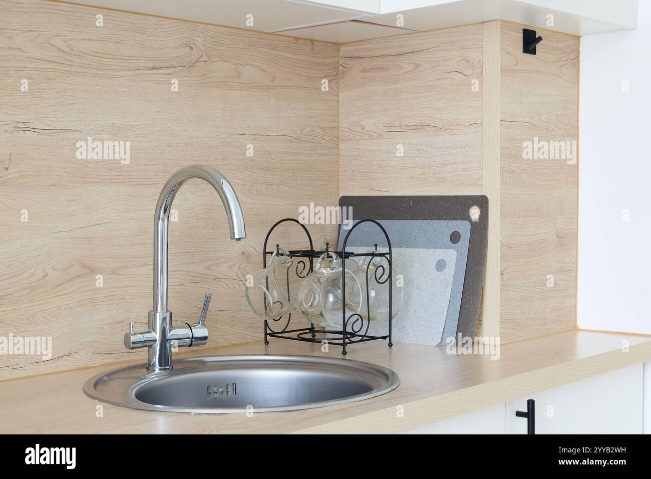 A modern kitchen sink that features stylish accessories complemented by ...