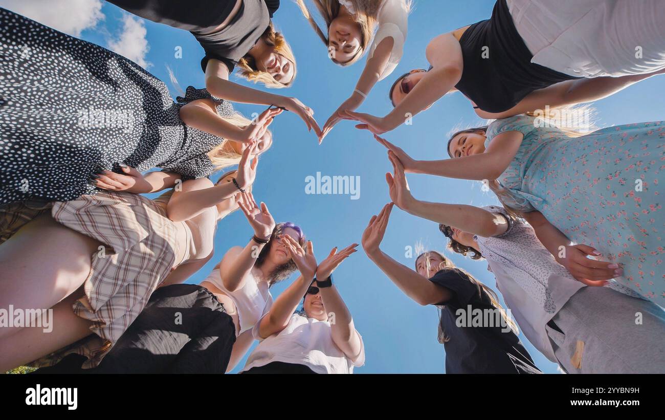 Group of high school students forming heart shape with hands ...