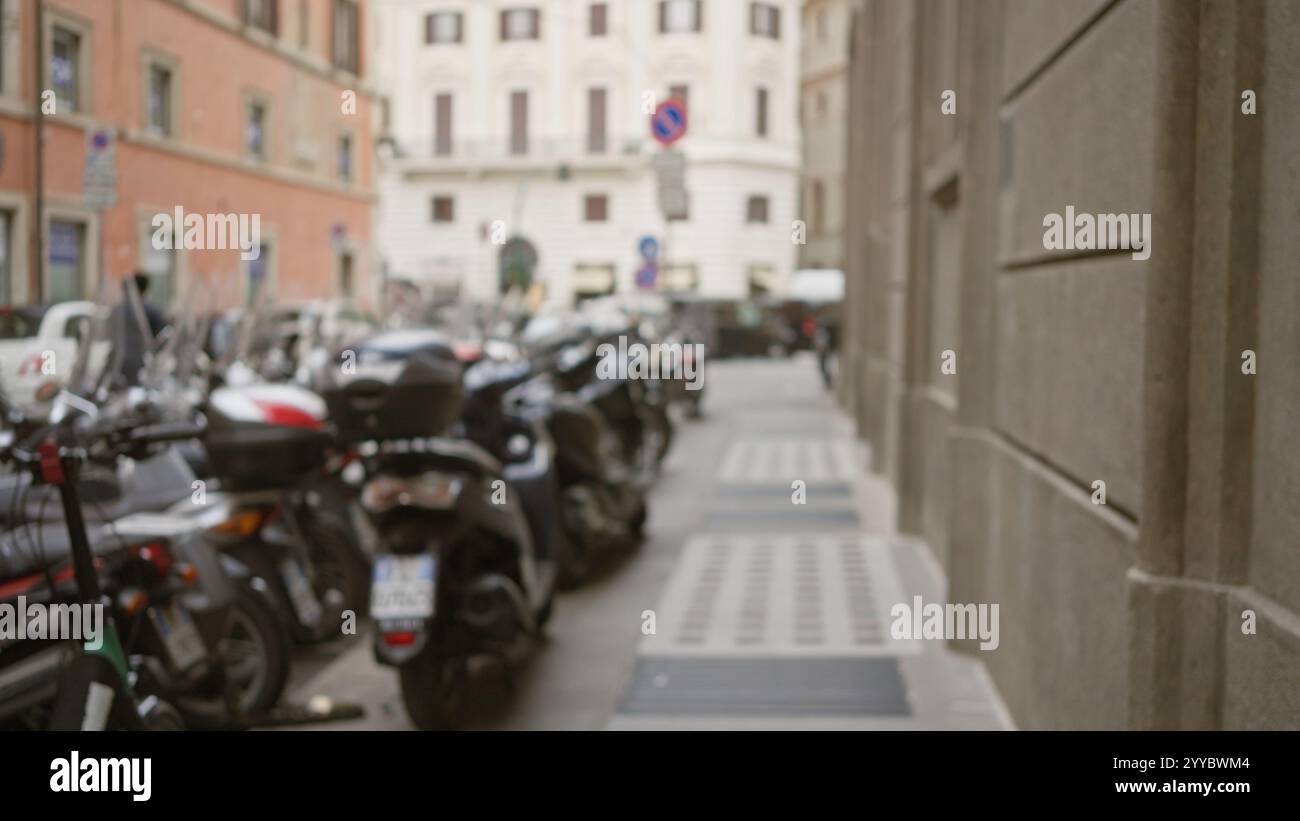 Bokeh street scene in rome with blurred background showing scooters ...