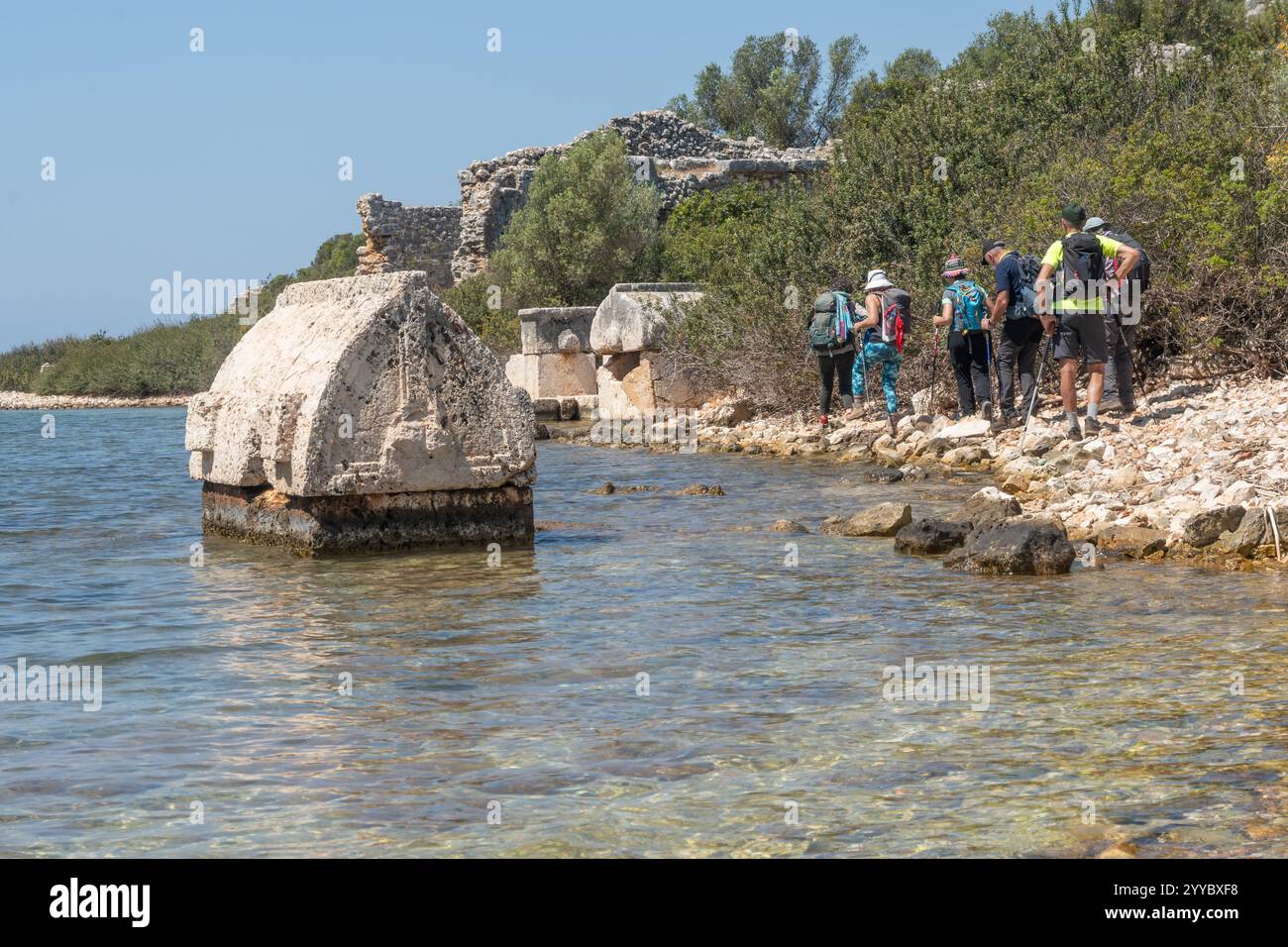 Explorers traverse the ancient ruins along the serene coastline ...
