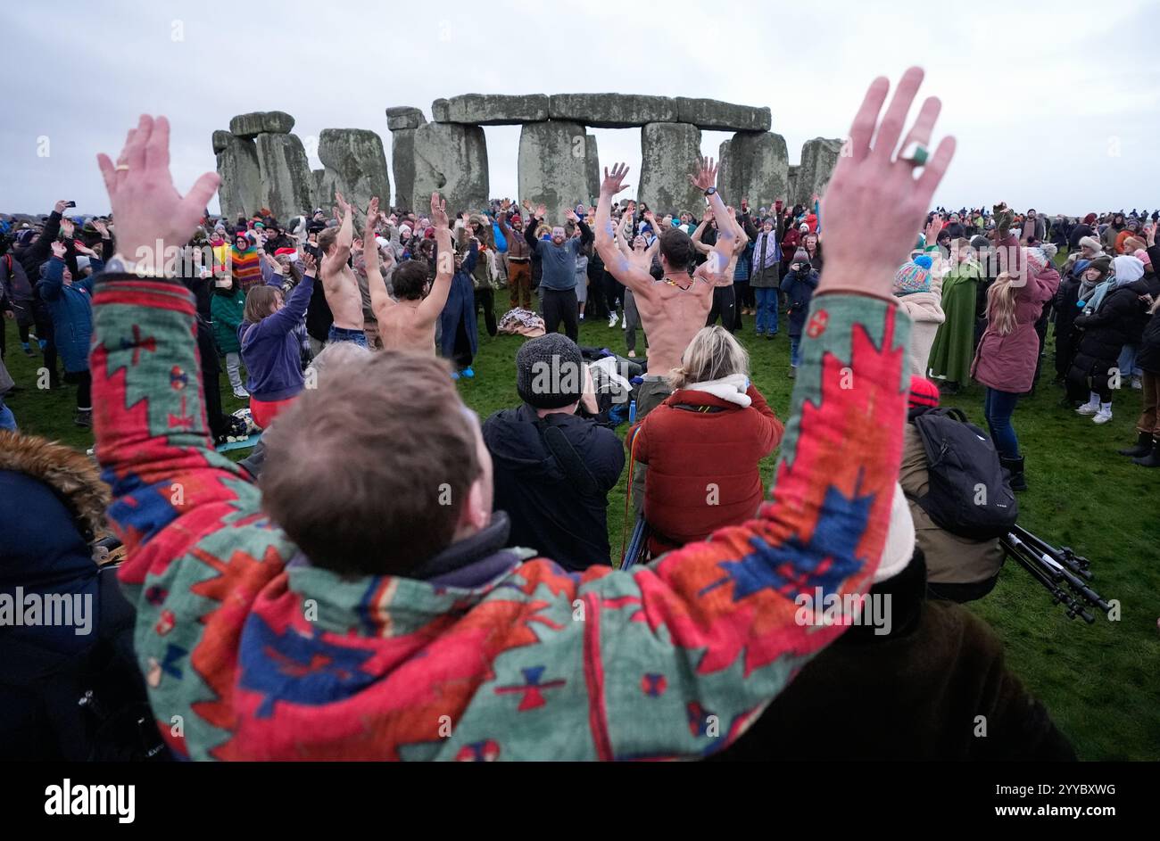People take part in the winter solstice celebrations during sunrise at