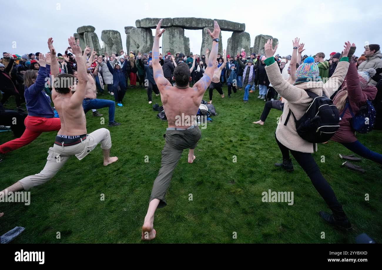 People take part in the winter solstice celebrations during sunrise at