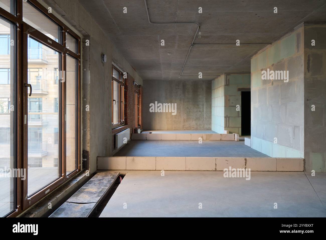 Picture of An Open Concept Industrial Style Interior Space Featuring Large Windows ...