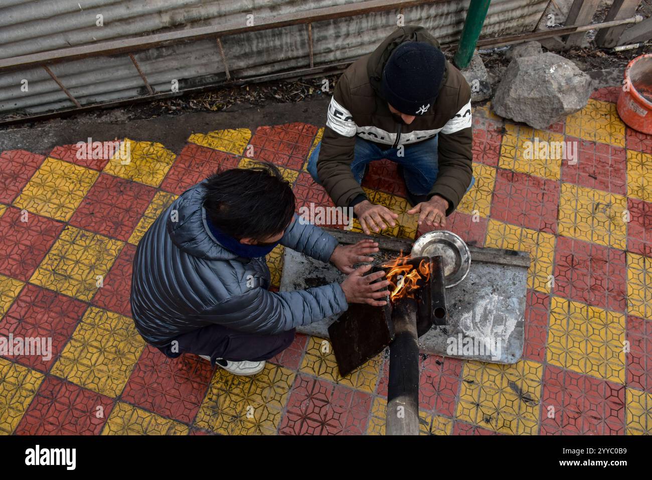 residents-gather-around-a-bonfire-to-keep-themselves-warm-following-the