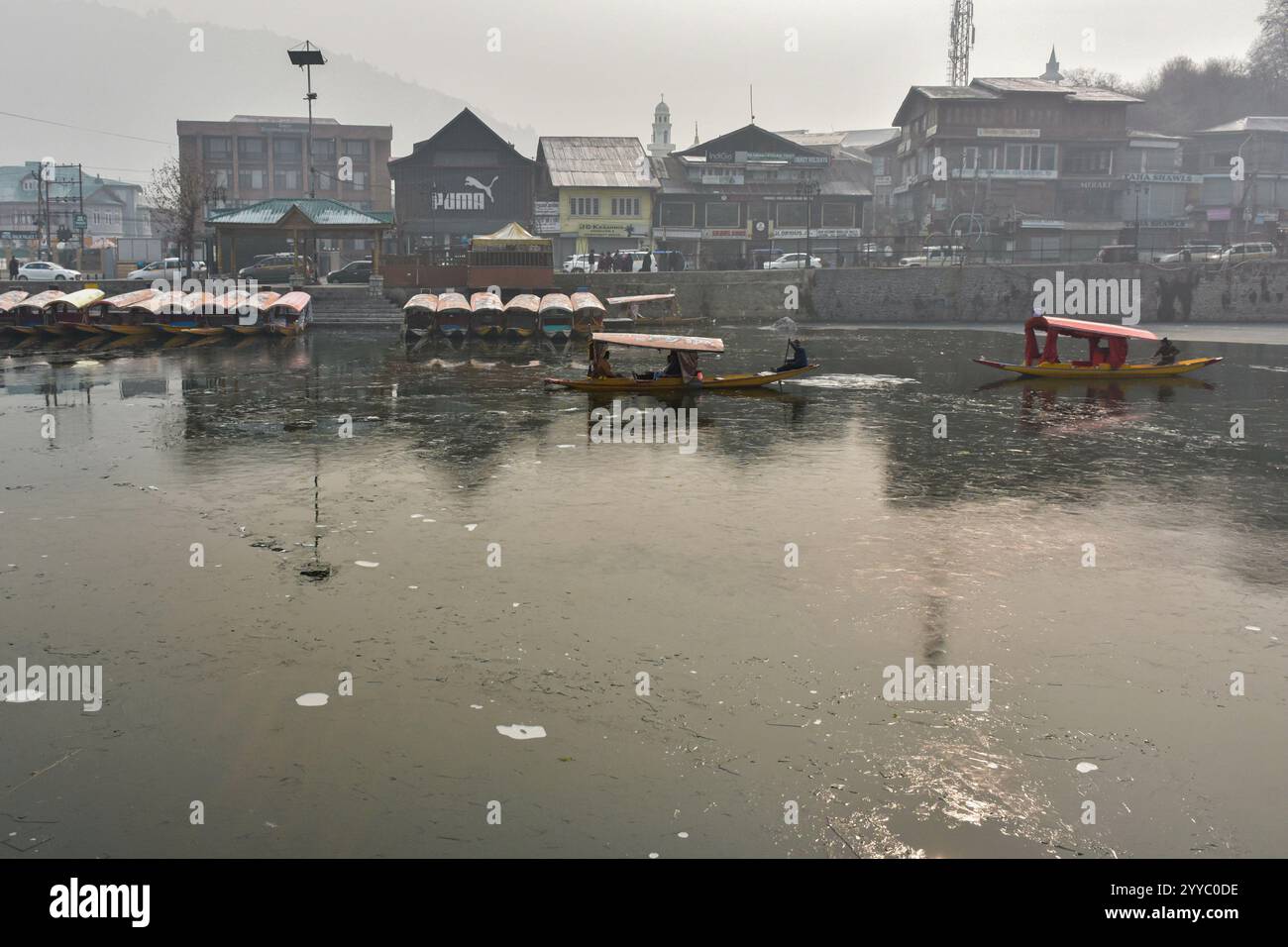 boatmen-ferry-tourists-across-the-partially-frozen-dal-lake-following