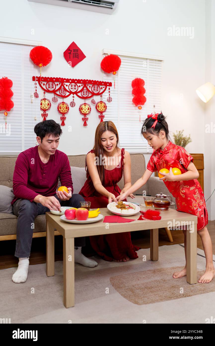 A Chinese family of three arranges a festive dining table to celebrate ...