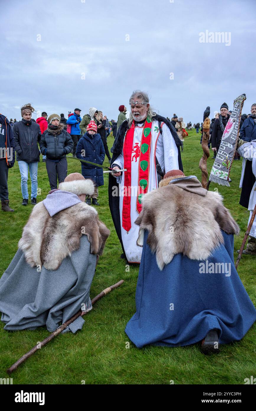 Salisbury, UK. 21st Dec, 2024. Druids celebrate at sunrise on the