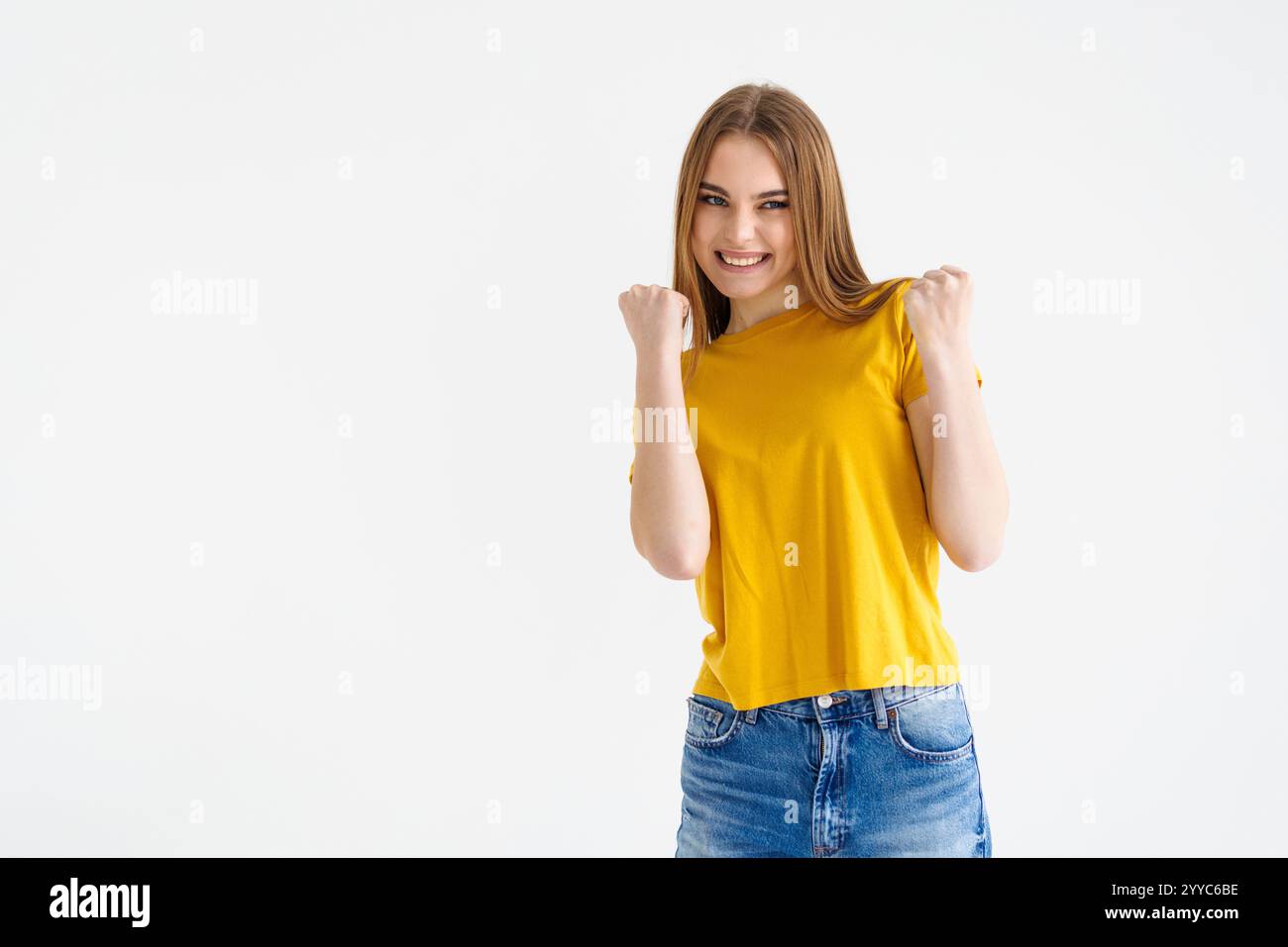 Image of happy young woman winning prize, making fist pump and smiling ...
