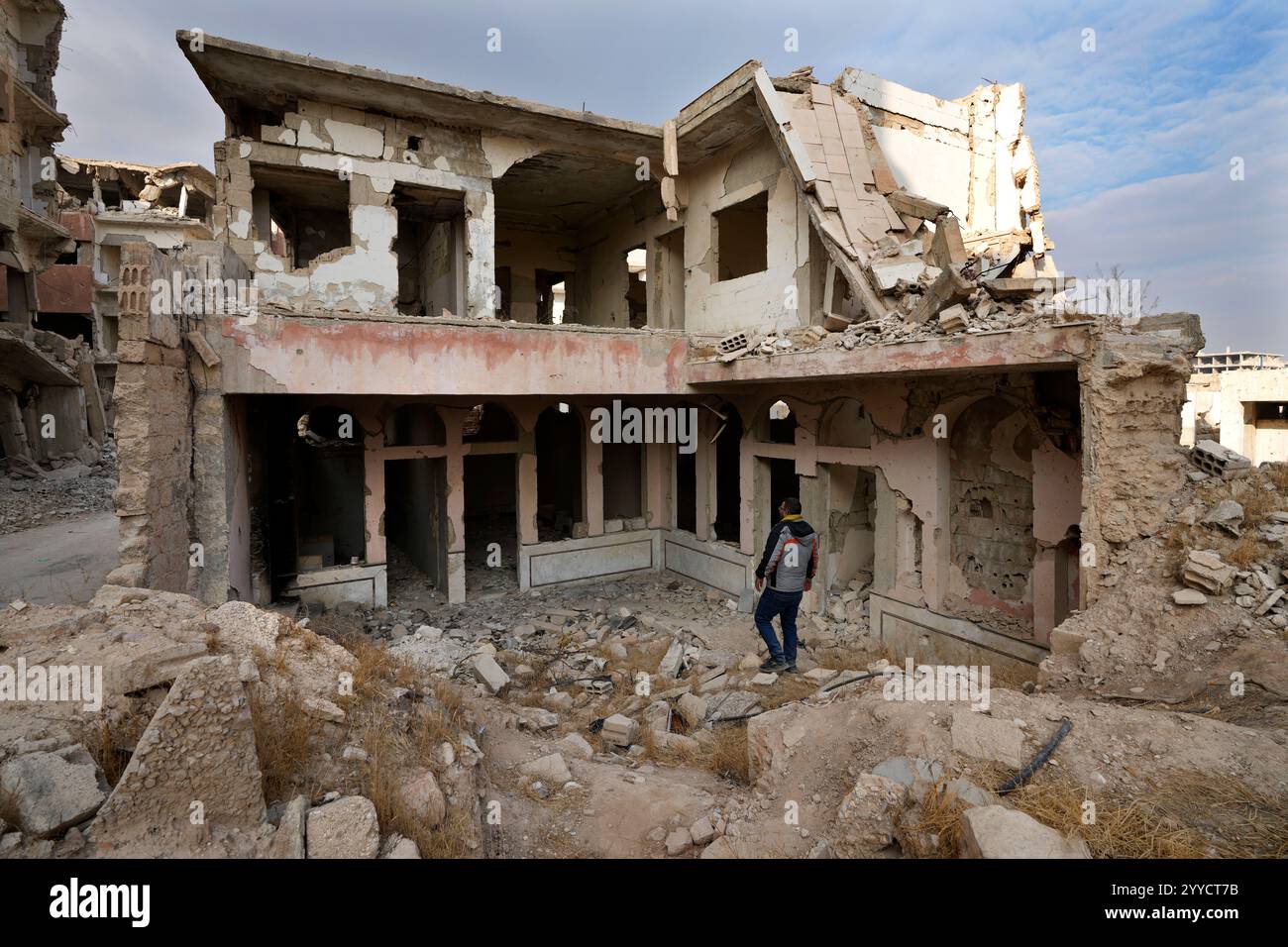 A Syrian man observes a Synagogue in the neighbourhood of Jobar, in ...