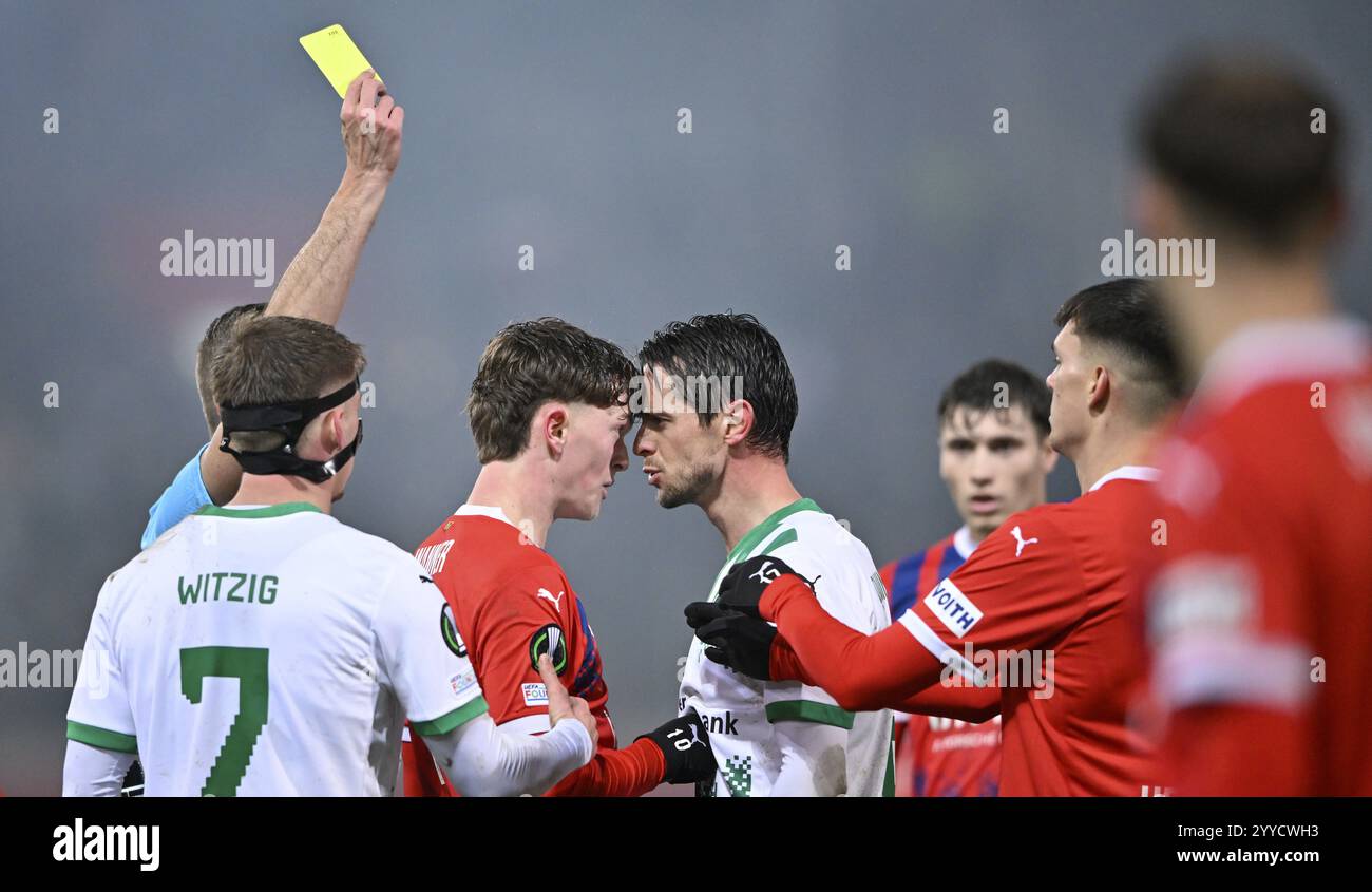 Paul Wanner 1. FC Heidenheim 1846 FCH (10) and Jordi Quintilla FC St. Gallen (08) clash Referee Javier Alberola Rojas (ESP) shows yellow card to both Stock Photo