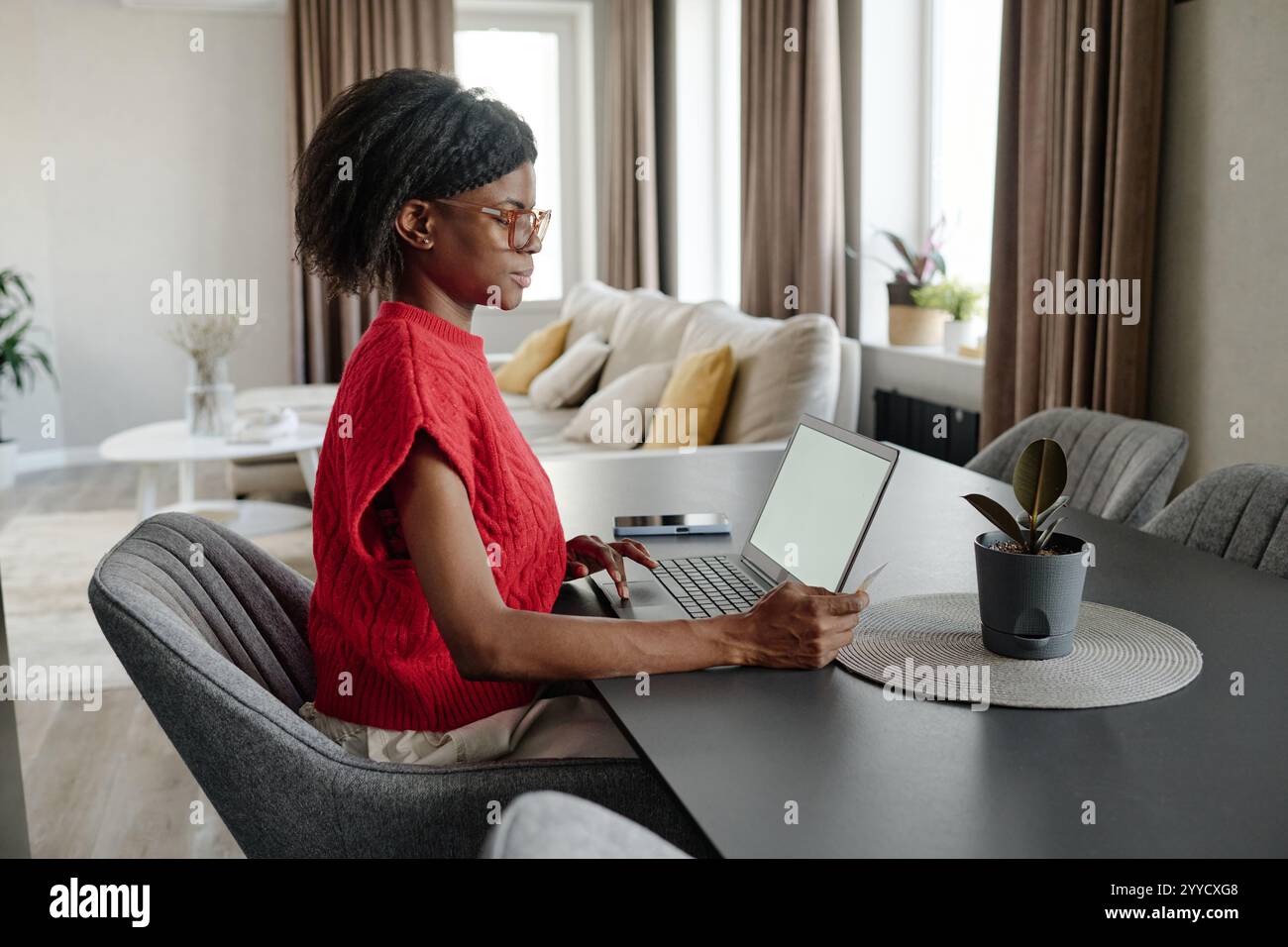 African woman sitting side view hi-res stock photography and images - Alamy